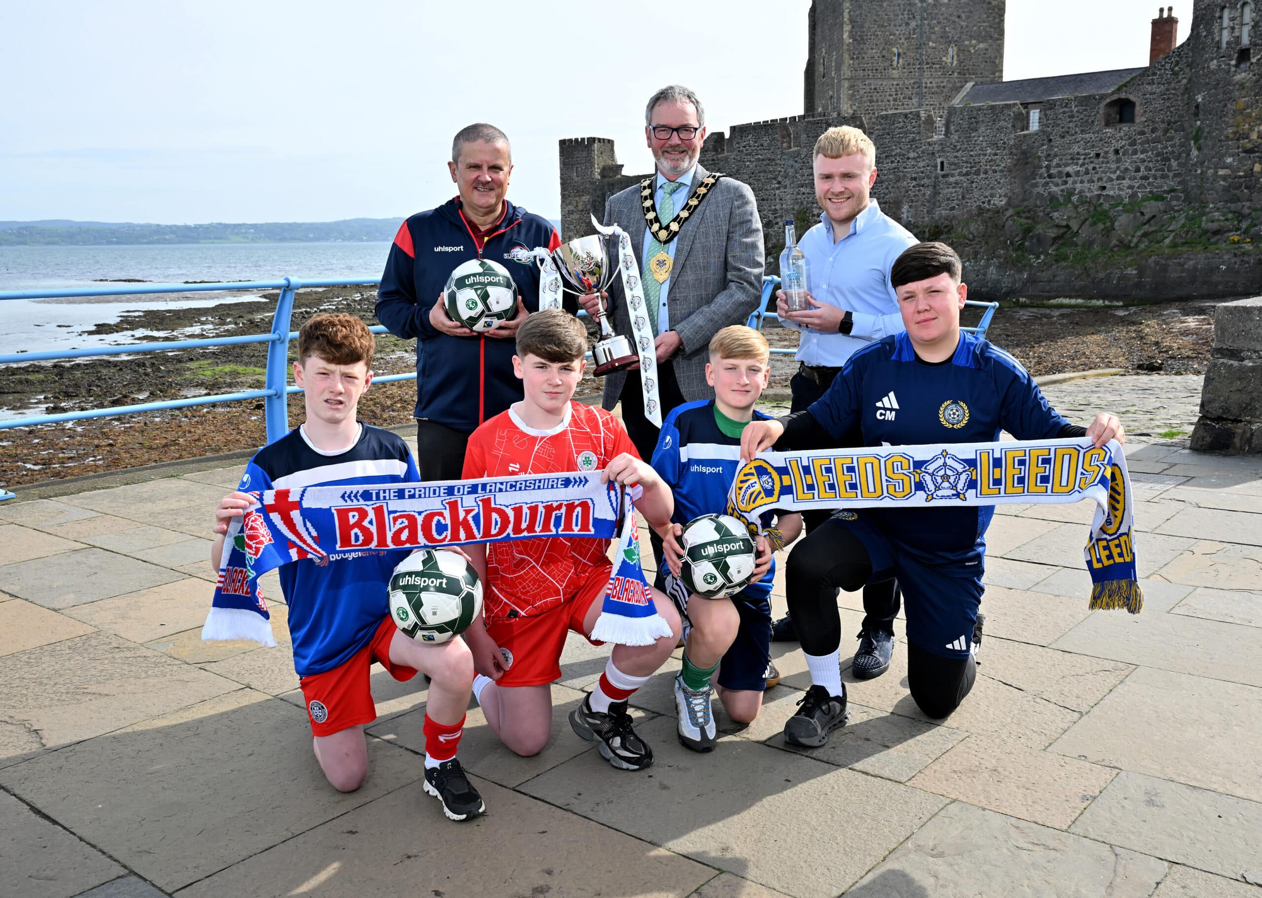 Shankill Juniors players Kylan Morrison and Carter McAllister, along with Cliftonville’s Keagan O’Connor and Ronan Vernon, are pictured with Alderman William McCaughey, Mayor of Mid & East Antrim Borough Council; Michael Willis, Director of the Budget Energy SuperCupNI; and Ollie Booth, National Account Manager at Clearer Water, to announce that Premier League newcomers Leeds United and Championship giants Blackburn Rovers will headline a world-class line-up in the Boys’ Minor Section at the 2025 Budget Energy SuperCupNI.