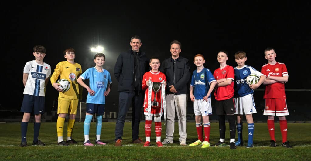 Sam Gamble, Tournament Coordinator at the Budget Energy SuperCupNI, and Karl Bradley, Marketing Executive at Budget Energy, are pictured with young players as the tournament confirms the eight Northern Ireland representatives for the 2026 Boys’ Minor Section — the first official team announcement ahead of next summer’s 43rd edition. Pictured left to right are Callum McCabe (Rosario YFC), Dylan Harkin (Maiden City), Archie Muir (Ballymena United), Flynn Johnston (Cliftonville), Luke Duddy (Linfield), Lorcàn Duffy (Newell Academy) and Ben Robinson (Glenavon), representing a strong local contingent of elite clubs and leading grassroots clubs set to feature at the 2026 Budget Energy SuperCupNI.