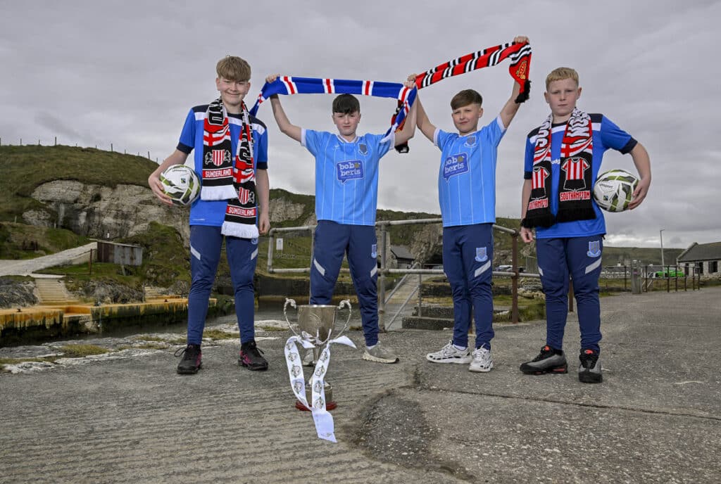 Ballymena United 2013s players Cole Logan, Curtis McKeown, Mason Buxton and William Shannon are pictured at Ballintoy Harbour as the Budget Energy SuperCupNI confirms its 2026 Boys’ Premier Section line-up, featuring Manchester United, Sunderland, Rangers and reigning champions Southampton.
